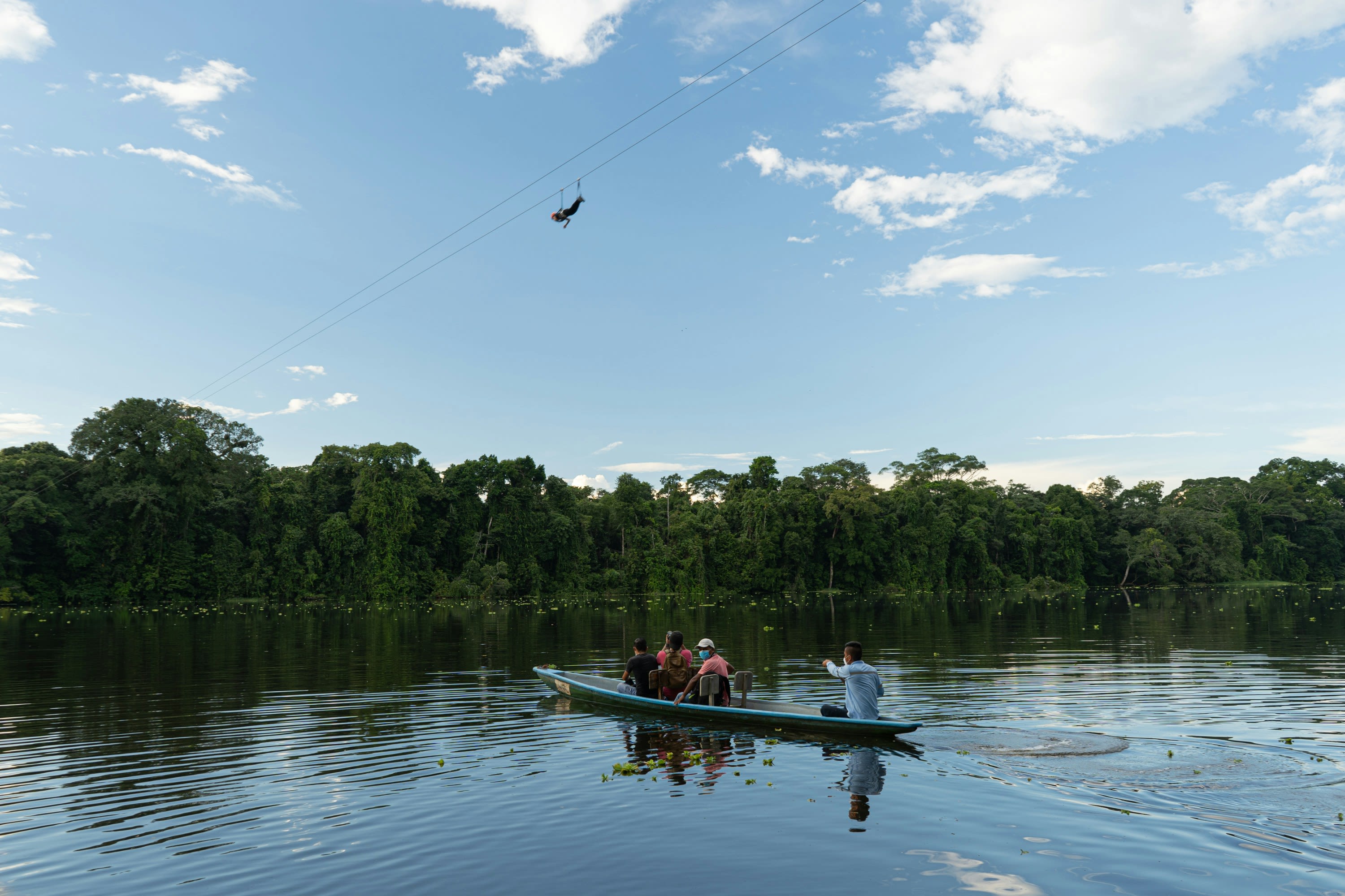 people riding on boat on lake during daytime